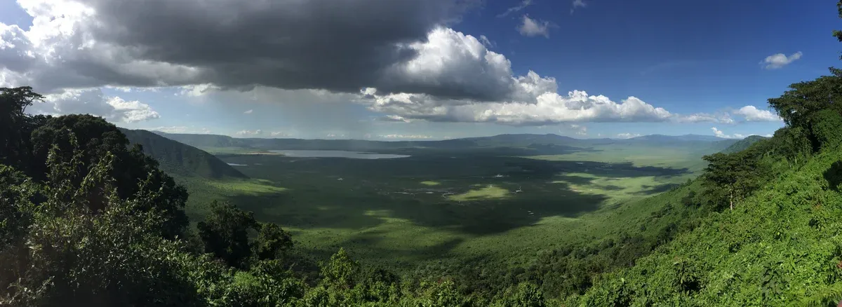 View across the Ngorongoro Crater from the rim under broken cloud, included in many Serengeti safari packages