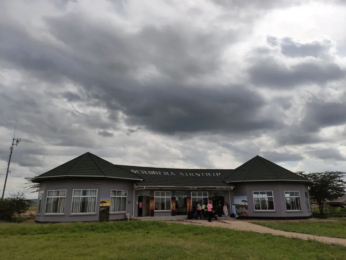 The Seronera airstrip terminal building under heavy cloud in the central Serengeti, used by fly-in Serengeti safari packages